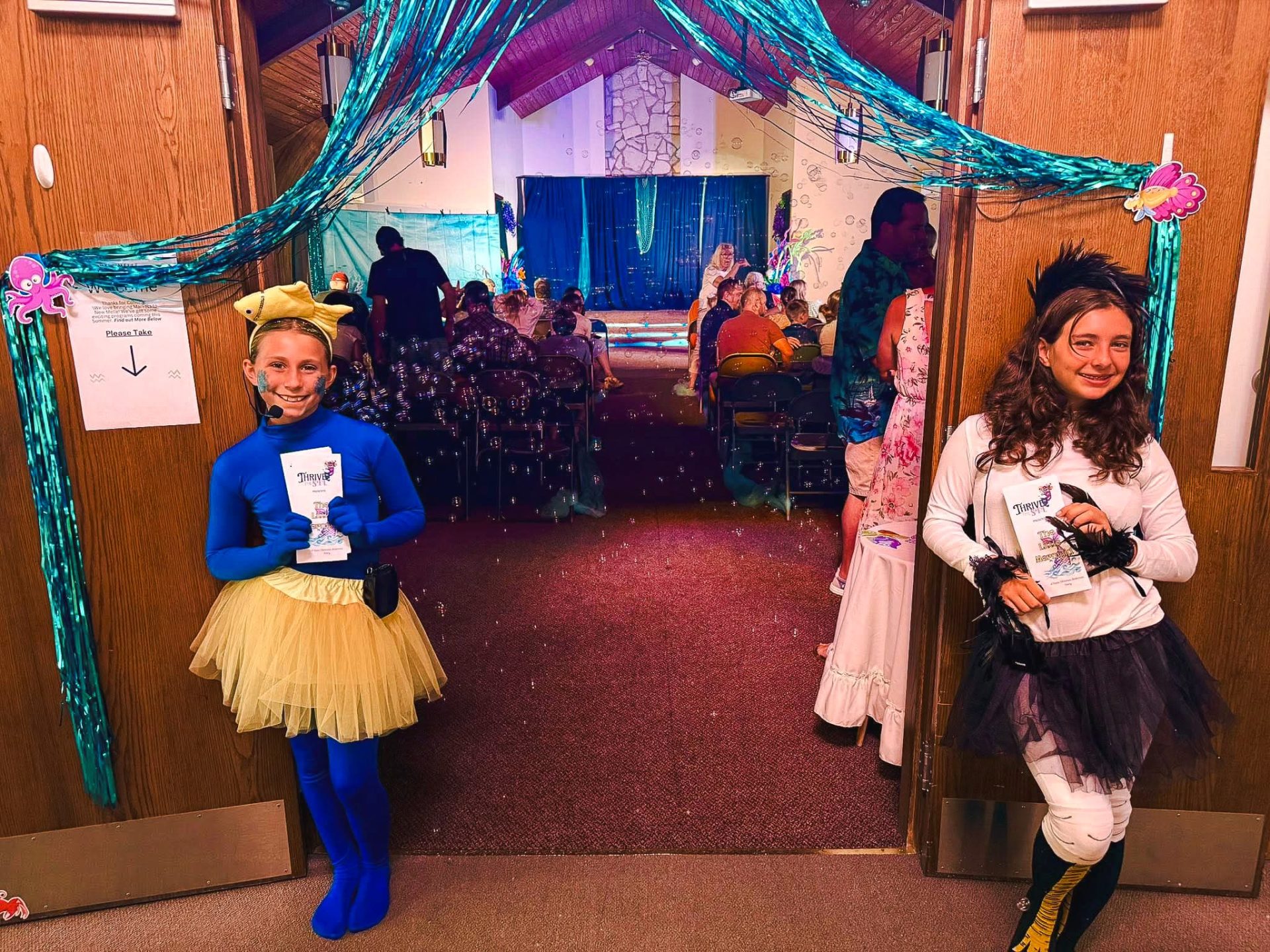 Two children actors in the Little Mermaid, a Thrive Theatrics Products, welcoming visitors at a showing held at Friedens Community Center
